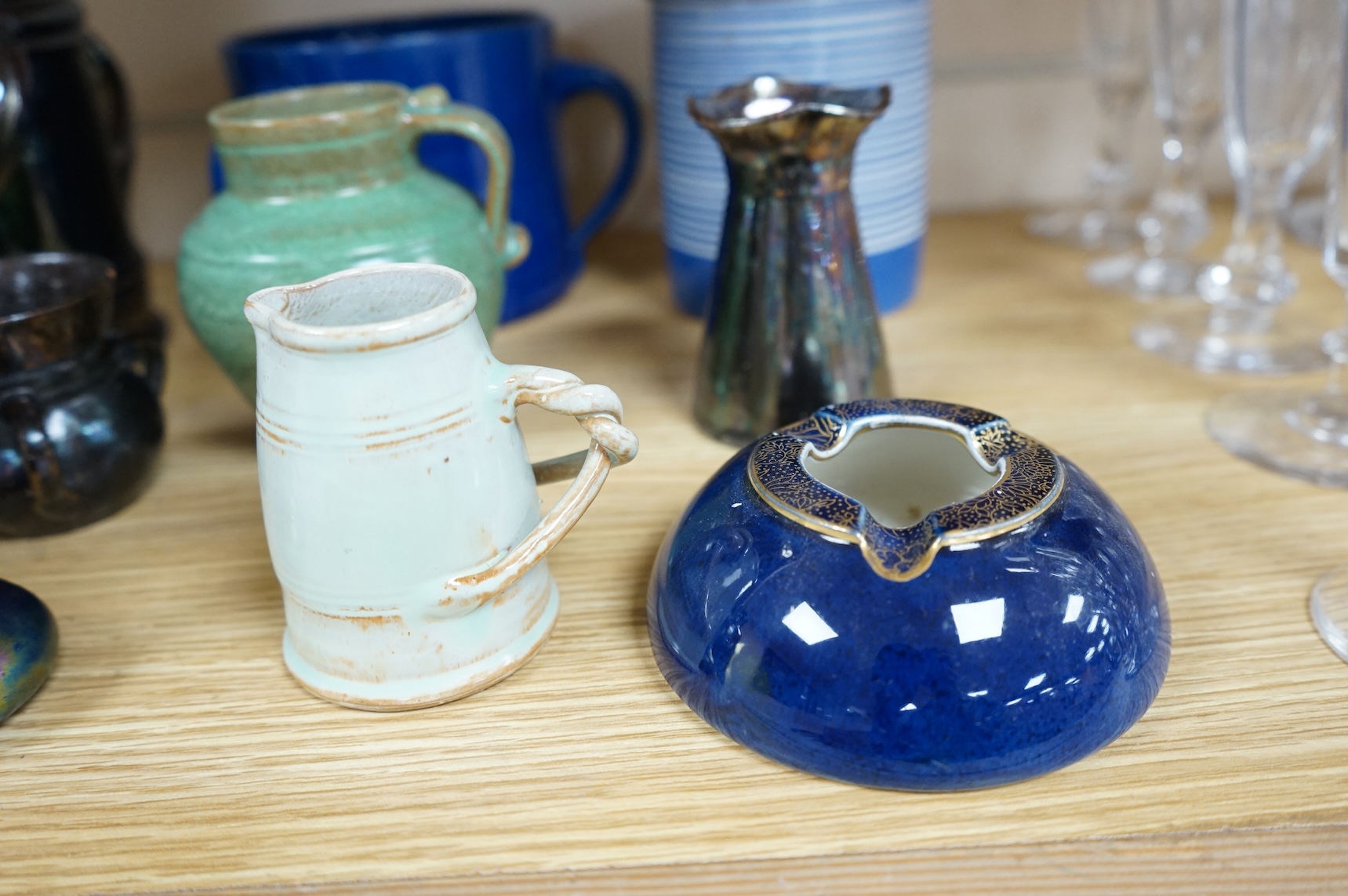 A collection of pottery to include lustre glazed jugs and tygs, a T. G. Green storage jar, Carltonware ash tray and a miniature Ruskin style vase, largest 18cm high
